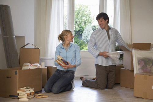 Movers carrying furniture down stairs in Highbury